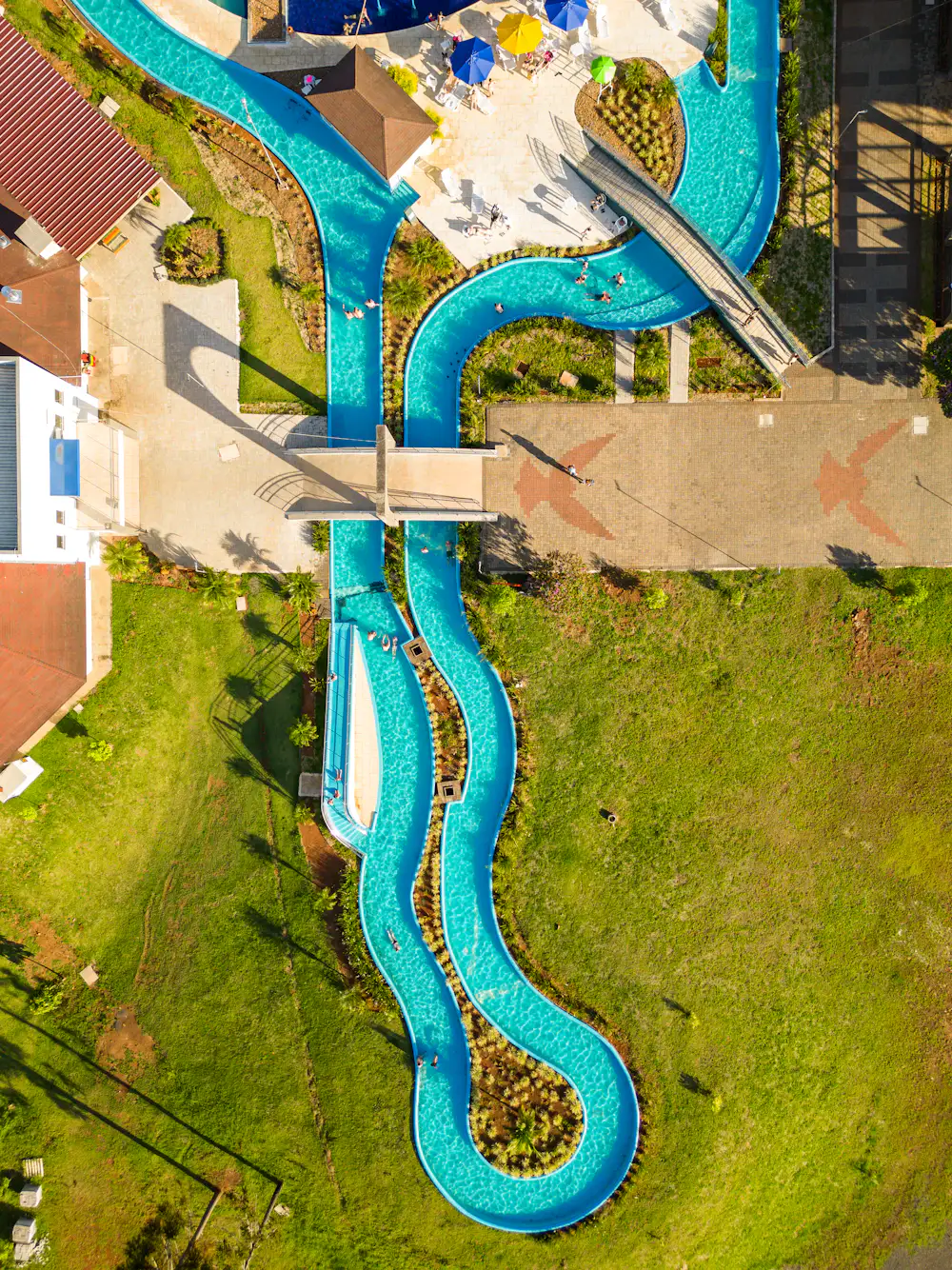 Aerial view of a winding turquoise lazy river — reference photograph