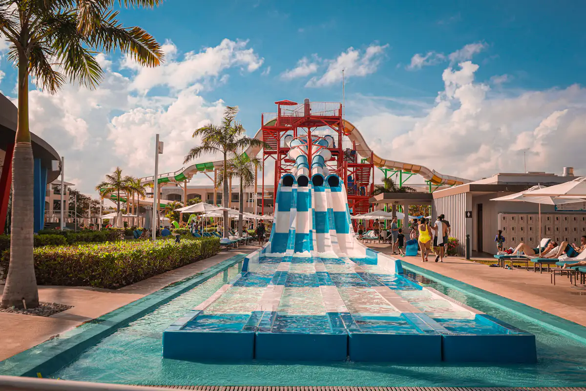 Illustrative photograph of sunlit pool water and palms